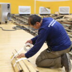 Staff bundling flooring at Basketball Court Water Damage Restoration