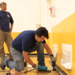 Staff working on Gym Floor Molding Work